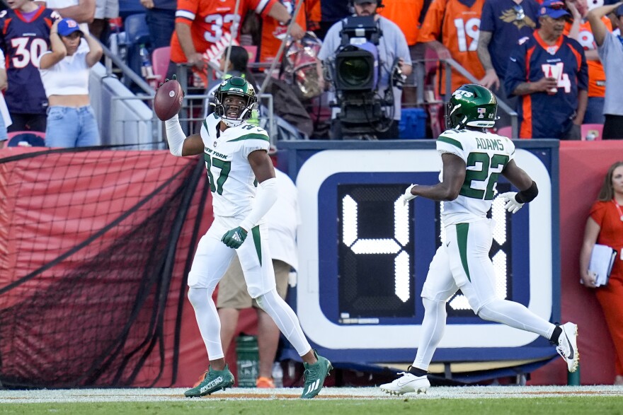 New York Jets cornerback Bryce Hall celebrates after scoring on a fumble recovery against the Denver Broncos during the second half of an NFL football game Sunday, Oct. 8, 2023, in Denver. (AP Photo/Jack Dempsey)