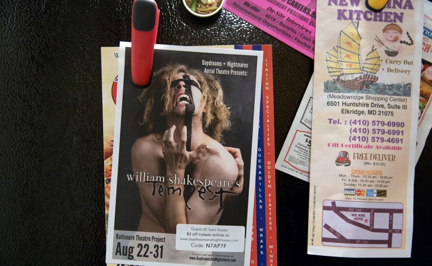 A flier for a production of <em>The Tempest</em> hangs on Younes' refrigerator. He will play the part of Alonso with the DNA Theatre in Baltimore. After his transition, theater became a big part of Younes' life, a way for him to express himself and socialize with other people.