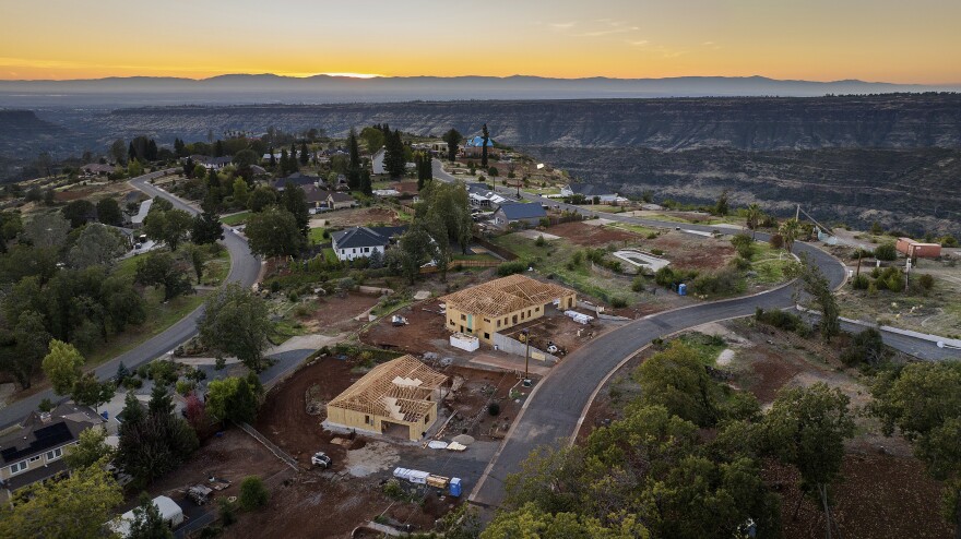 The sun sets over Valley Ridge Drive, Thursday, Oct. 26, 2023, in Paradise, California, five years after the Camp Fire.