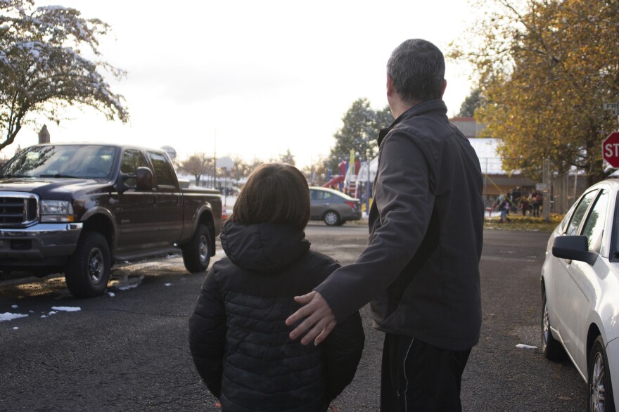 After his release from detention, Manuel walks with one of his sons near the local elementary school. Manuel still hasn't received proper documentation to work. As a result, the oldest son remains the family's biggest breadwinner, and his schooling is left on hold.