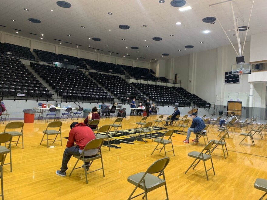 People sitting in a high school gym.