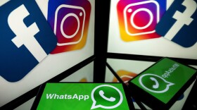 Logos of US social networks Facebook, Instagram and mobile messaging service WhatsApp on the screens of a smartphone and a tablet. (Lionel Bonaventure/AFP via Getty Images)