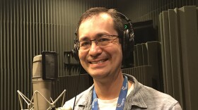 man  wearing headphones and smiling