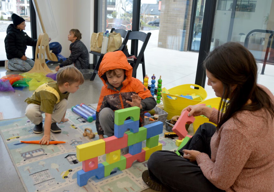Erica Segal, director of the Central Oregon Children’s Museum, builds a foam block structure with her sons, Graham Segal, 3, and Lincoln Segal, 6, at a pop-up museum event on Oct. 11, 2026 in Bend.