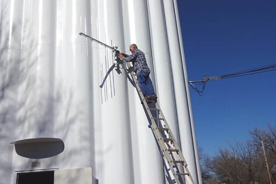 KOSU contract engineer Bob Buford mounts an antenna to the side of a water tower in Ponca City in 2015.