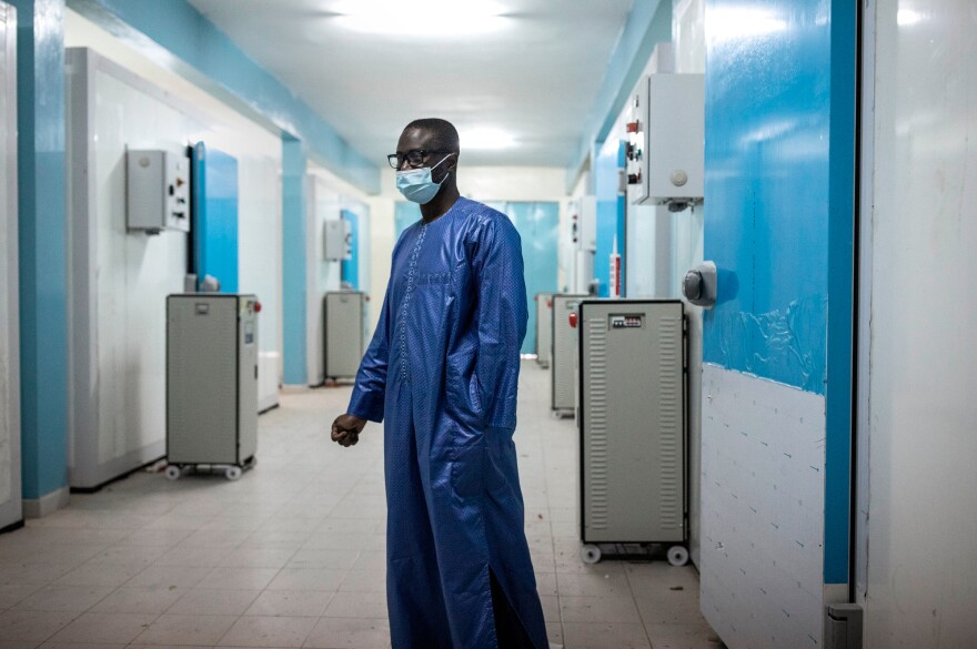 Ousseynou Badiane, head of Senegal's vaccination program, stands in front of newly built cold rooms at Fann Hospital in Dakar on Jan. 22, 2021. These cold rooms may be used to help store the country's stock of COVID-19 vaccines.