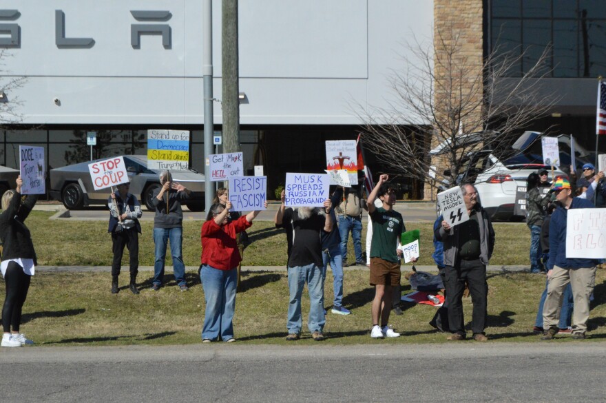 Protestors gather at Tulsa's Tesla store on Saturday, March 22, 2025.