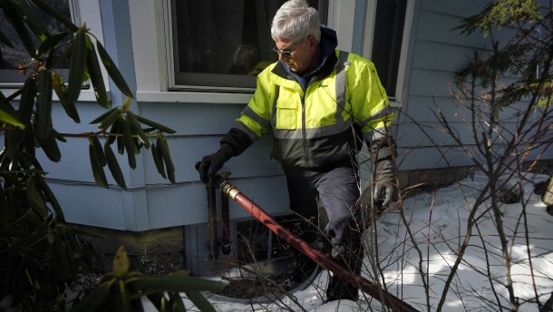 Peter Ellingwood, of Bob's Cash Energy, delivers heating oil, Tuesday, Jan. 31, 2023, in Farmington, Maine.