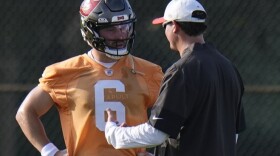Buccaneers quarterback Baker Mayfield  talks to offensive coordinator Josh Grizzard during practice. 