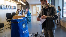 Taylor Miller prepares to cast his ballot during early voting on Monday in Renton, Wash. King County has had the highest number of deaths in the U.S. linked to the coronavirus outbreak.