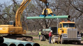 Workers at a site of a pipeline under construction along state Highway 75 north of Horntown.