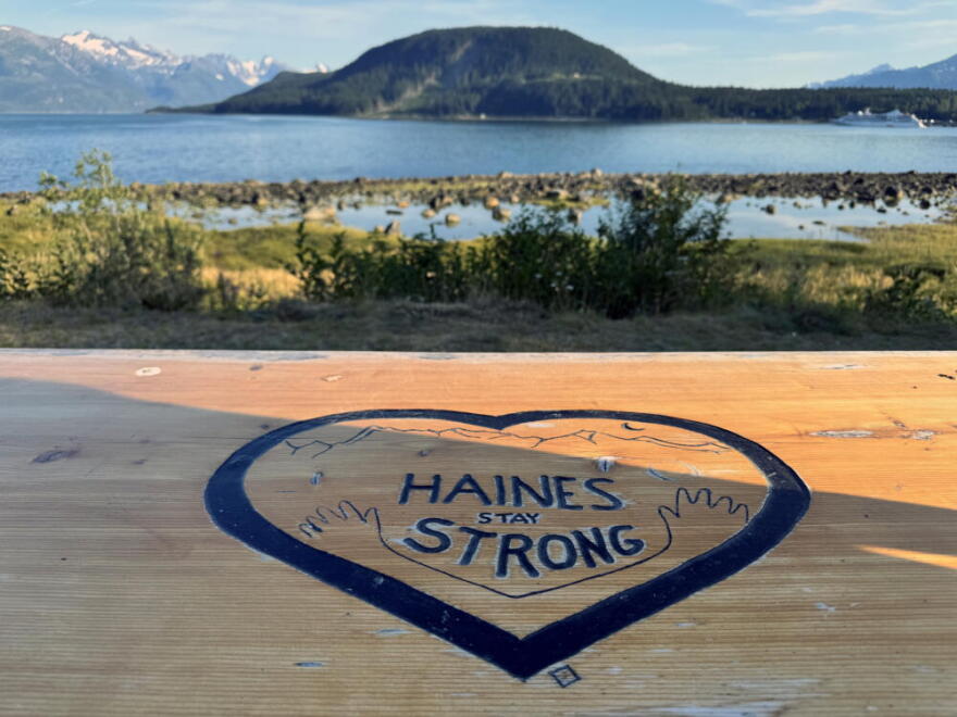 A table carved with the words “Haines Stay Strong.” (Chris Bentley/Here & Now)