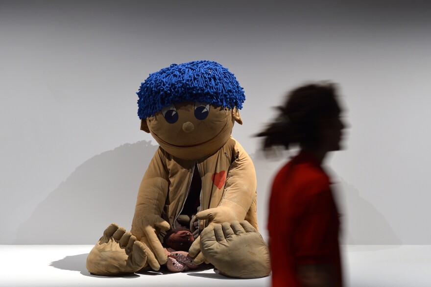 A visitor walks past an exhibit in the <a href="http://www.labiennale.org/en/art/exhibition/55iae/">Encyclopedic Palace</a>.