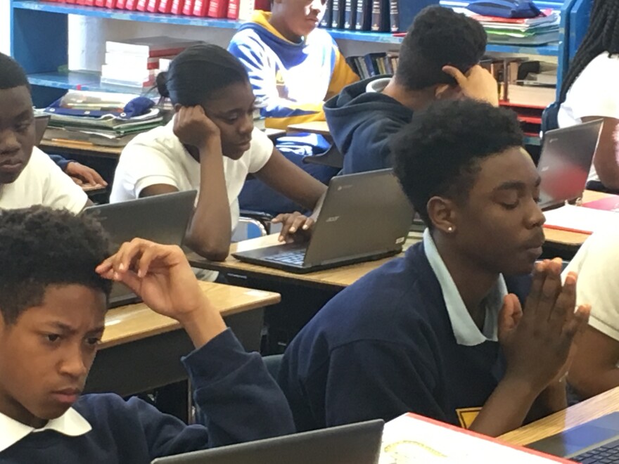 Jr. high students at St. Francis working on their computers, one part of blended learning at the school.