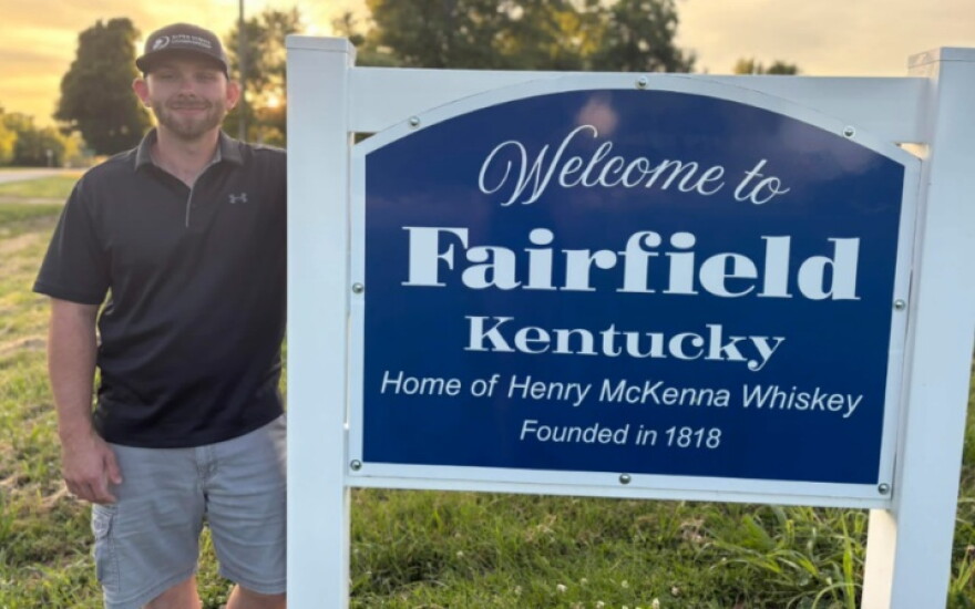 A recent photo of Herbie Hardin by the Fairfield, Kentucky sign.