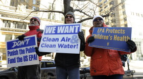 Protesters hold signs during a rally and protest by government workers and concerned citizens at Post Office Square near the Federal building, headquarters for the EPA and IRS in Boston, on Friday, Jan. 11, 2019. (Joseph Prezioso/AFP via Getty Images)
