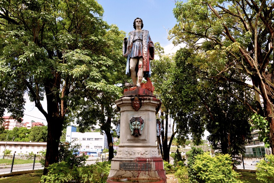 FILE - A vandalized statue of Christopher Columbus towers over Columbus Square in Port of Spain, Trinidad and Tobago, on Aug. 28, 2024.