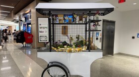 A cart with fresh produce and free samples introduces travelers to the Akron-Canton Airport's new market, which sells products from local farms and businesses, on July 22, 2026.