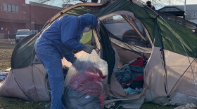 A city worker removing items from a tent in Seminary Park on Jan. 14.