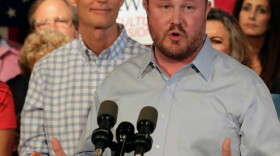 Florida Republican candidate for Commissioner of Agriculture Matt Caldwell speaks as Gov. Rick Scott listens during a rally Sept. 6, 2018, in Orlando.