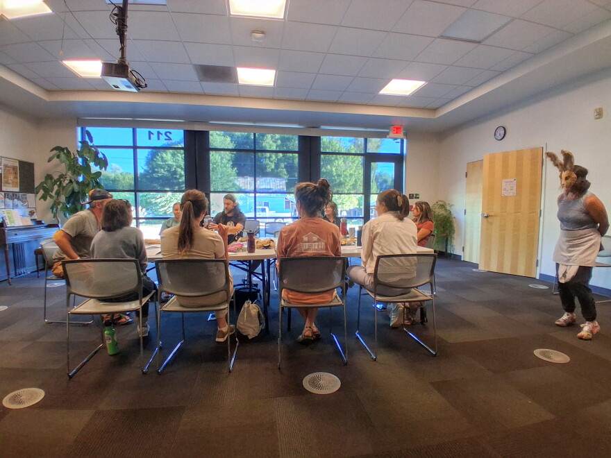 A group of actors rehearses an argumentative dinner scene at the Mancos Public Library ahead of the Golden Fox Paradox.