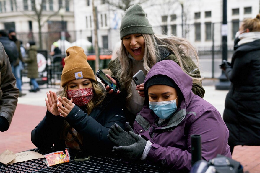 Ariana Avalos, 24, stands behind sisters Cynthia Cortez, 21, left, and Teresa Cortez, 19, in downtown Washington, D.C. All three came from California to watch the inauguration.