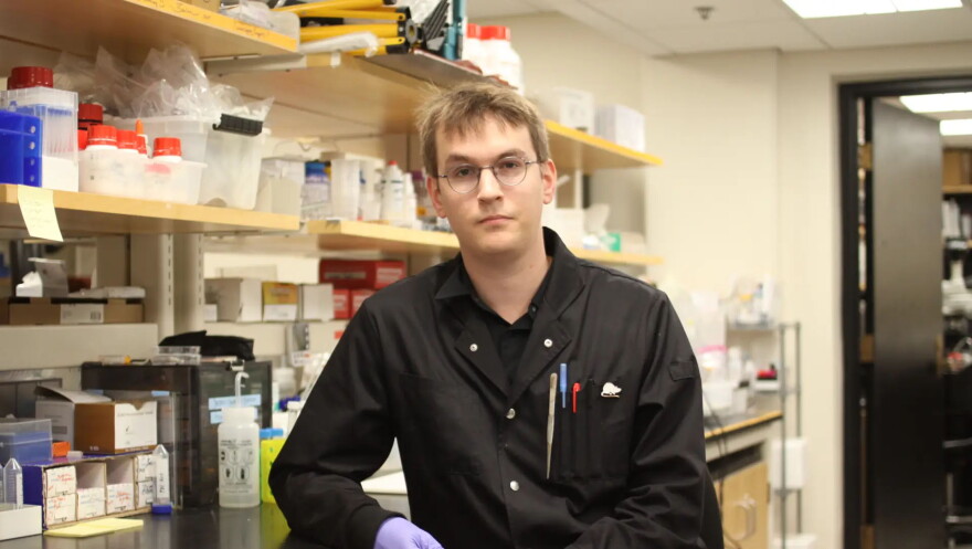 Bastien Aymon sits at his lab bench at MIT. The fourth-year PhD candidate from Sion, Switzerland says the Trump administration’s proposed new four-year visa cap is creating a chilling effect on international talent. “It adds a lot of uncertainty and stress in our daily lives for sure,” he says.