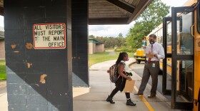 A student boards the school bus at the end of the school day.