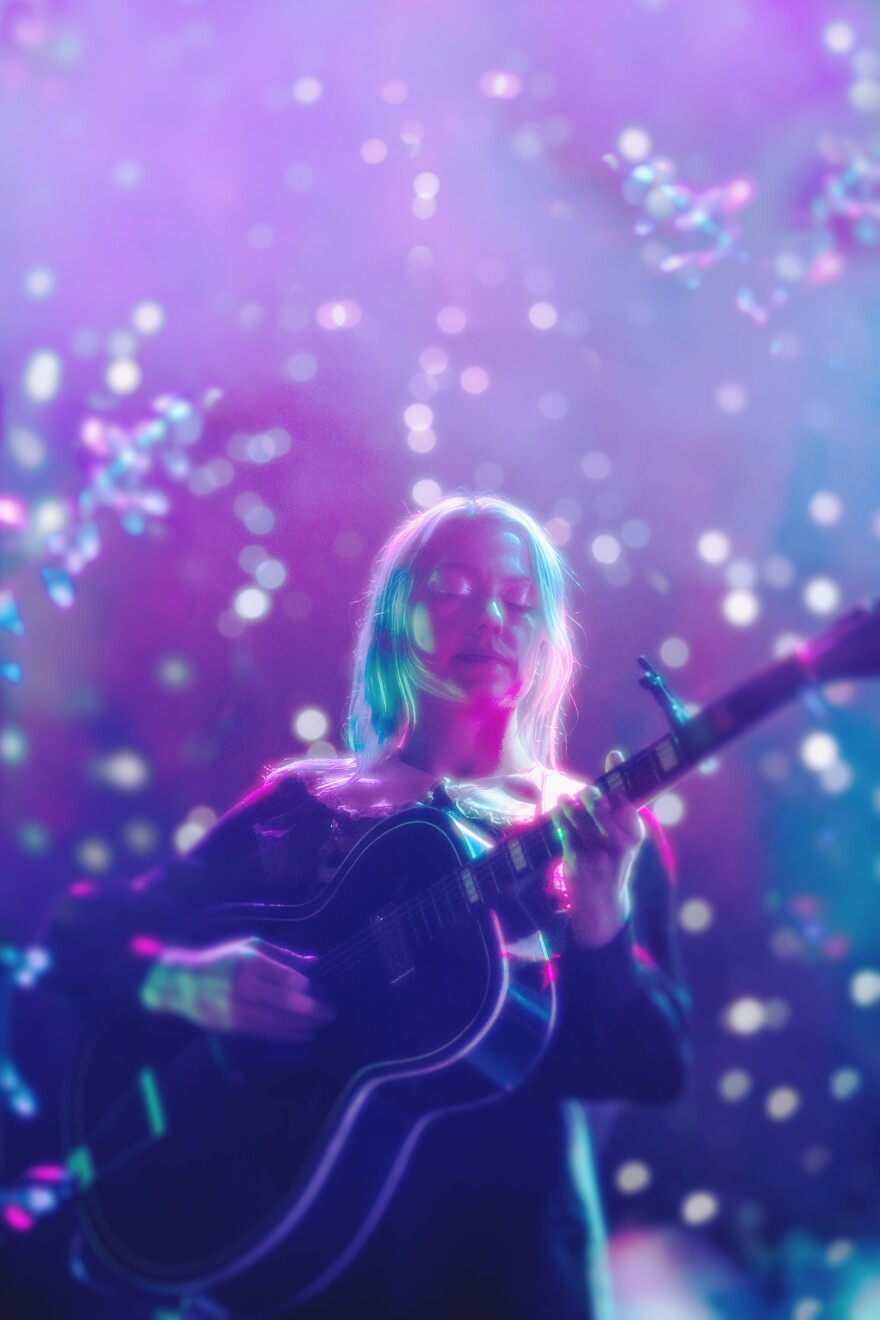 a woman playing guitar 