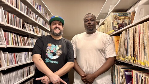 Cooley the Curator and T Hunt pose for a photo in the music library.