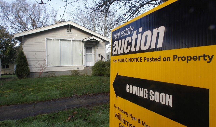 An auction sign in front of a Salem, Ore., home on Feb. 23.