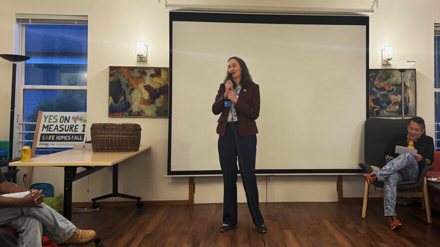 Seattle Mayor Katie Wilson speaks in front of several people in a room.