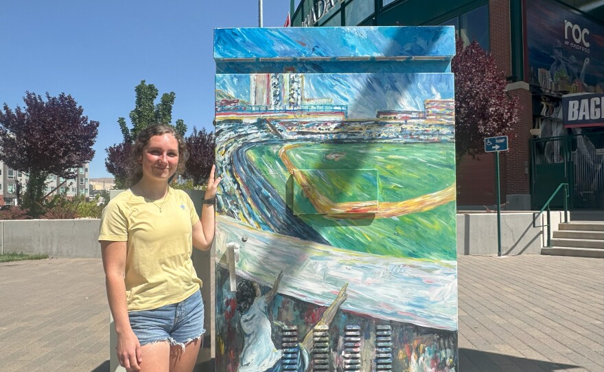 Blair Latos stands next to her signal box outside of the Greater Nevada Field Stadium.