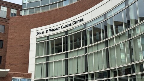 The red brick, white stone, and glass facade of the James P. Wilmot Cancer Center building