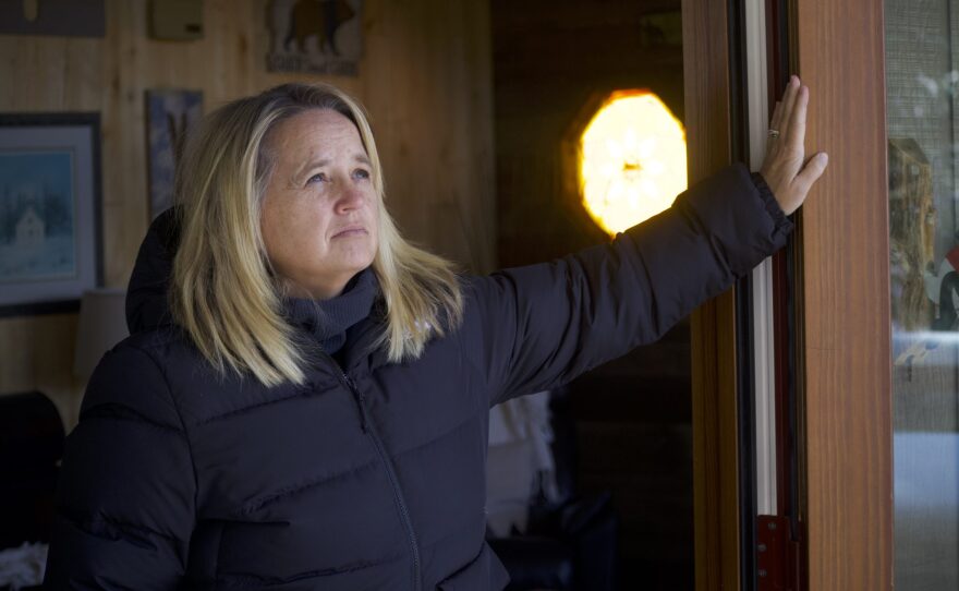 Laura James stands at the main entrance to her two-bedroom, three-bathroom home in Breckenridge on Wednesday, Feb. 28, 2024. Dubbed "The Cabin," the home was built by James's parents in the mid-1970s, the first property of what could become the Peak 7 neighborhood. After buying it from her parents, James and her husband have short-term rented the home in order to pay for their mortgage and other expenses in a bid to keep the home in their family. But faced with new Summit County regulations on short-term rentals, James said that prospect is becoming much harder.