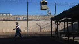 An immigrant inmate walks for exercise at the Maricopa County Tent City jail on March 11, 2013, in Phoenix. (John Moore/Getty Images)
