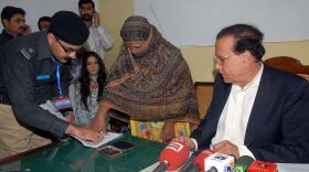 At the jail where she was held in 2010 after being sentenced to death for blasphemy, Asia Bibi affixed her thumbprint as signature on a mercy petition to Punjab's provincial governor, Salman Taseer, at right. Taseer had expressed support for Bibi and was assassinated two months later.
