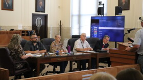 (From left to right) Grady County Commissioners Zachary Davis, Ruth Bingham and Gary Bray sit next to Grady County District Attorney Jason Hicks at a meeting on September 8.