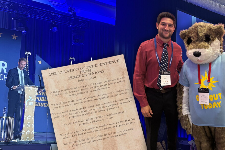 Tulsa Public Schools speech and debate teacher Micah Cash takes a picture with "Ollie the Opt Out Otter," a mascot at the Teacher Freedom Alliance (TFA) summer conference in July, where there was also a poster-sized "Declaration of Independence from Teacher Unions" sign encapsulating the organization's mission. In the background, Former Oklahoma State Superintendent Ryan Walters, now the CEO of TFA, speaks to a crowd of attendees during a banquet. The images used for clip art were provided by Cash.
