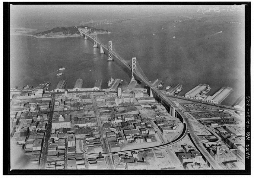 "Clyde Sunderland, Photographer November 9, 1936 AERIAL VIEW OF SUSPENSION BRIDGE TO YERBA BUENA ISLAND AND BEYOND FROM SAN FRANCISCO.