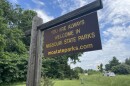 A large brown sign with yellow lettering says, "You are always welcome in Missouri state parks. mostateparks.com." The sign bids farewell to visitors leaving Rock Bridge State Park in Columbia, Missouri.