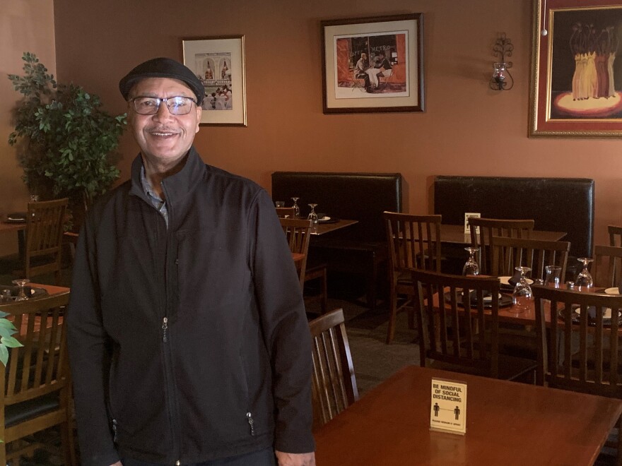 Clifton Freshwater stands inside his restaurant, Freshwaters, in uptown Charlotte. It was a struggle at first, but the restaurant has made it through the worst of the COVID-19 pandemic.