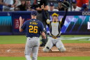 Milwaukee Brewers pitcher Aaron Ashby (26) and catcher William Contreras celebrates after the final out of Game 4 of baseball's National League Championship Series between the Milwaukee Brewers and the Los Angeles Dodgers, Thursday, Oct. 15, 2026, in Los Angeles. (AP Photo/Mark J. Terrill)