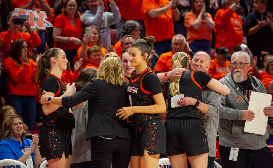 Girls high school basketball players inside an arena
