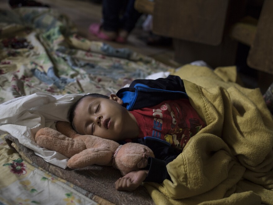 A Central American child who is traveling with a caravan of migrants sleeps at a shelter in Tijuana, Mexico, in April.