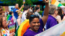  An attendee raises her fist smiling at the Pride in CLE march.  