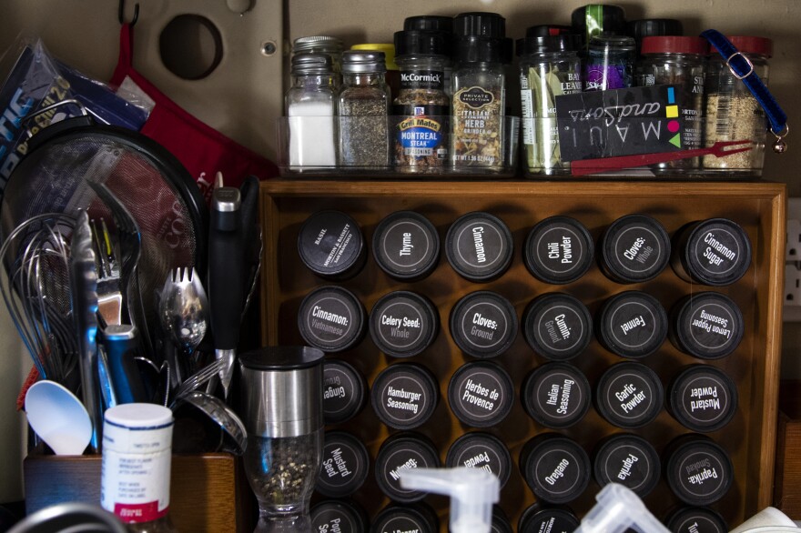 A spice rack is displayed in the cab of Brandie's truck. She has been studying culinary arts on her off days.