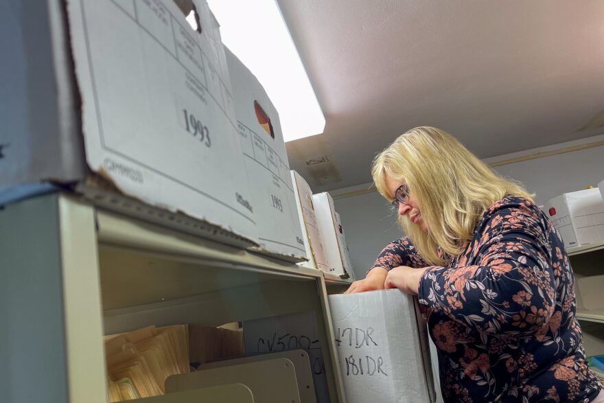 Iron County Circuit Clerk Sammye White balances on a stepladder as she searches for an old marijuana case in the office storage room in Ironton, Missouri.