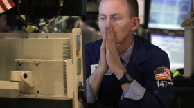 Specialist James Ahrens works at his post on the floor of the New York Stock Exchange Wednesday, Aug. 10, 2011. The stock market has fluctuated greatly since the United States' credit rating was lowered.