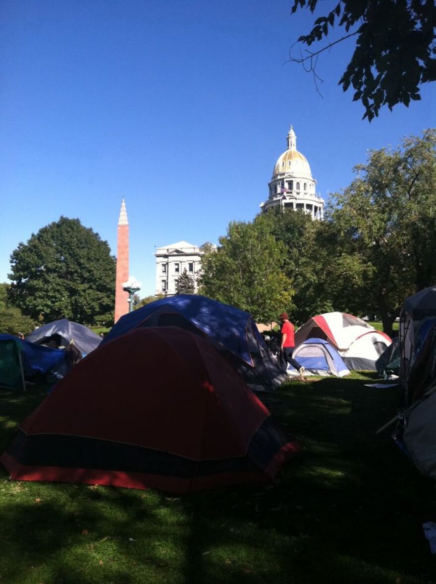 A protest against corporate greed mirroring "Occupy Wall Street" continued in Denver's Civic Center Park Wednesday, even as some worried authorities would try to remove the illegal campers.